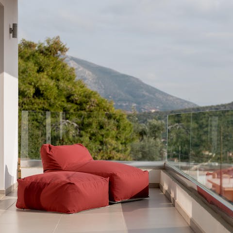 Lounge in the sunshine on the plush red bean bags with a good book and a glass of wine