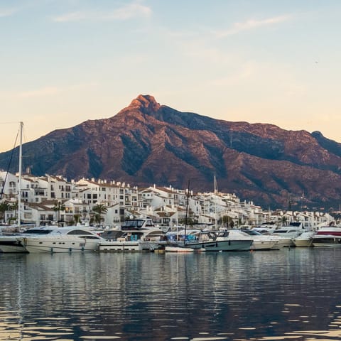 Admire the mountain views whilst strolling along the Marbella seafront