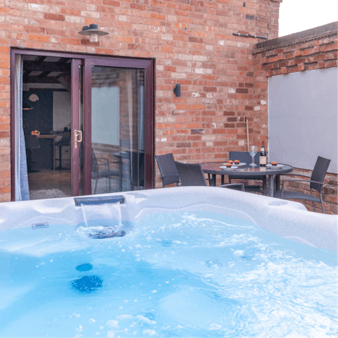 Slip into your swimwear and sit back in the hot tub in the back garden