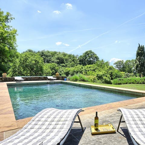 Bask in the Tuscan sun by the pool with a glass of vino