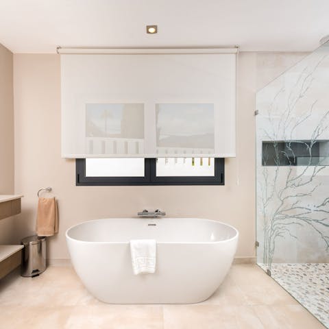 Treat yourself to an unrushed soak in one of the home's sleek bathtubs