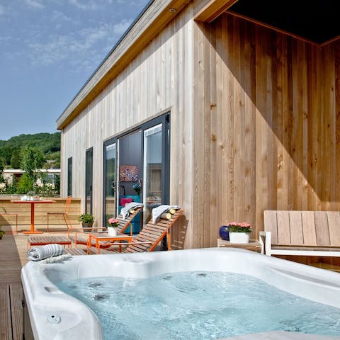 Sip a glass of fizz from your private hot tub 