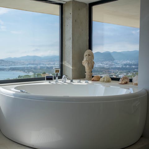 Sink into the hydromassage tub while sipping on a glass of local wine