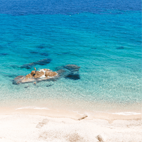 Sunbathe on Kalafatis Beach, just an eight-minute walk away