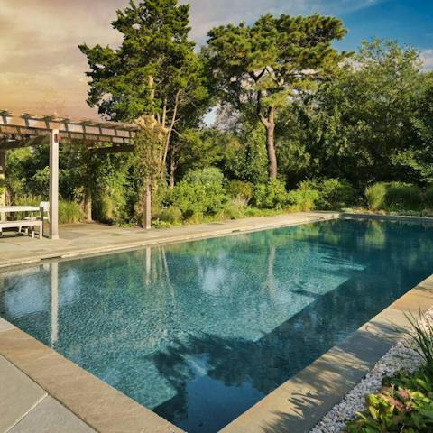 Take a dip in the saltwater gunite pool surrounded by lush gardens