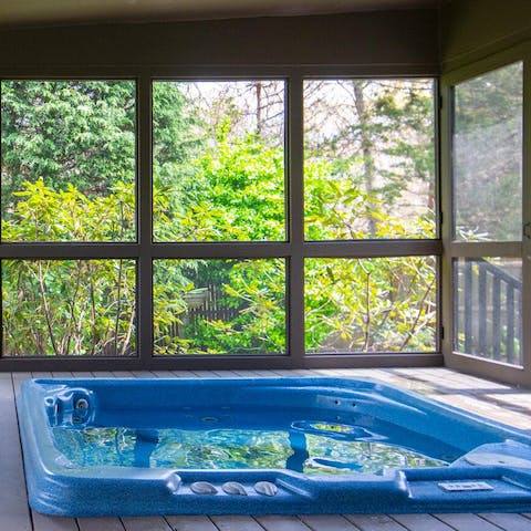 Unwind in the jacuzzi hot tub surrounded by luscious greenery