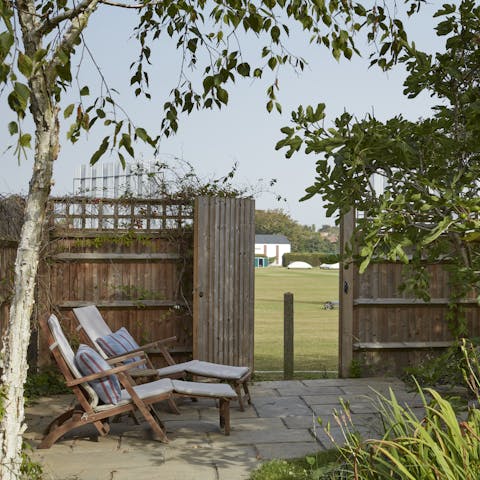 Enjoy a summer evening in the garden, which opens onto playing fields