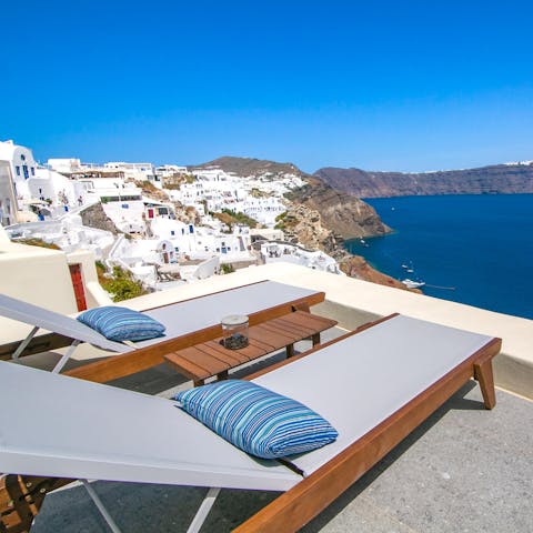 Sunbathe out on the terrace while enjoying the breathtaking views over Santorini