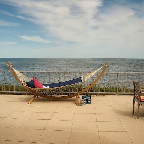 Settle in with a good book and watch the waves from the hammock