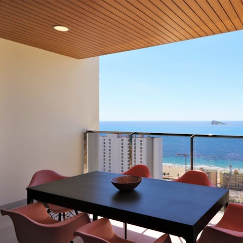 Gaze at stunning views of the sea from the dining set on your balcony