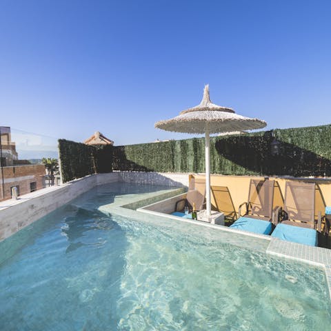 Head down the spiral staircase to the apartment's very own heated pool
