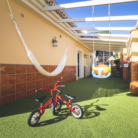 Doze off in the hammock while youngsters play with the bikes