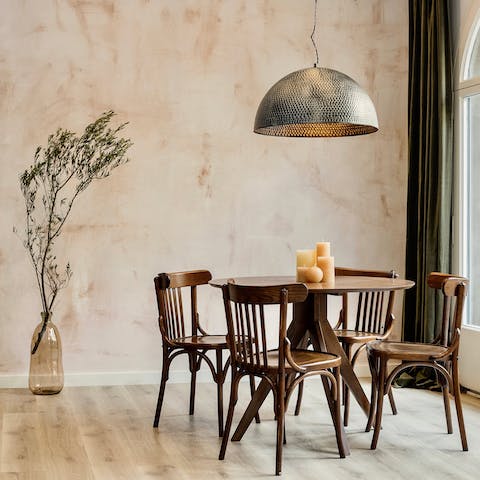 Dine in style under the modern lighting feature on antique-style chairs