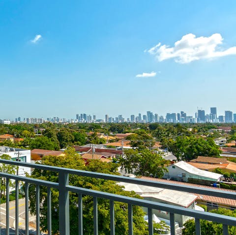 Relax on the private balcony with sweeping views of the city skyline