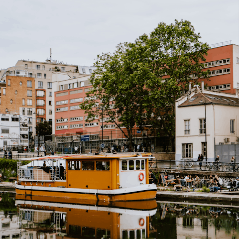 Make the most of waterside drinking and dining at the Canal Saint-Martin, fourteen minutes away