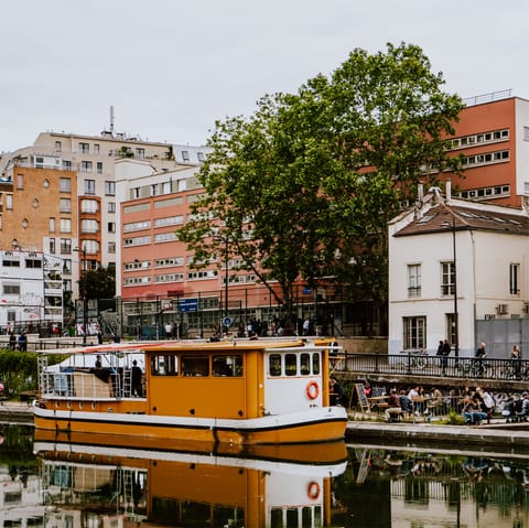 Make the most of waterside drinking and dining at the Canal Saint-Martin, fourteen minutes away