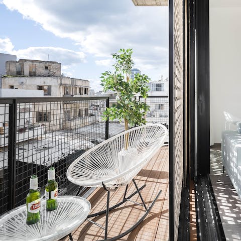 Relax and unwind on the private balcony, cool drink in hand 
