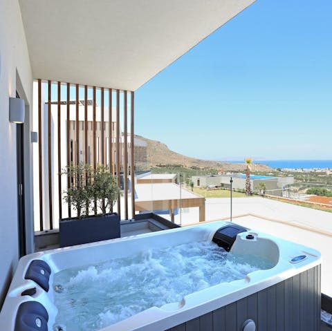 Unwind in the hot tub and enjoy the sea views