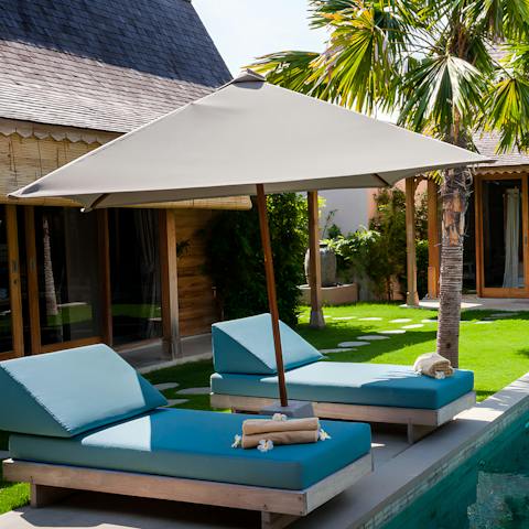 Soak up some vitamin D on the poolside day beds 