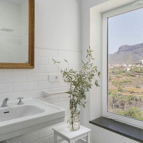 Peer out over mountain vistas with your morning shower