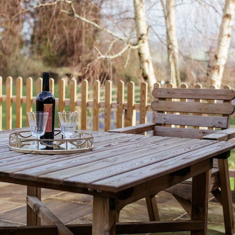 Bask in the idyllic setting on the patio, sharing a bottle of wine under the stars