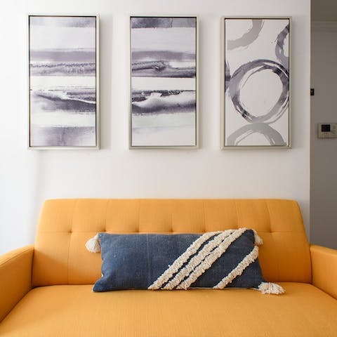 Kick back on the cheery tangerine sofa with a cool drink after a day of touring the Big Apple on foot