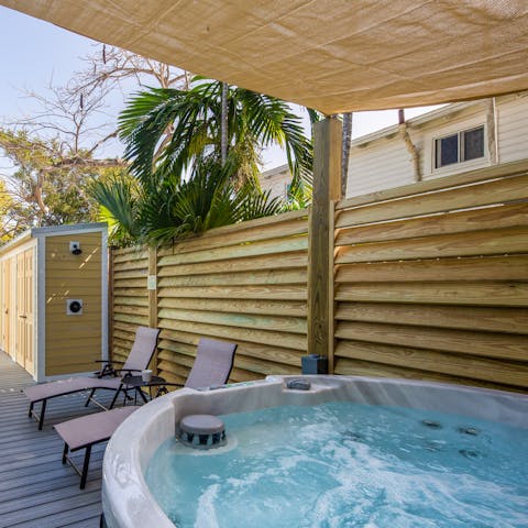 Soak in the bubbling hot tub, drink in hand