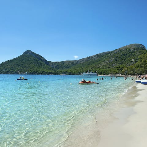 Sink your toes into the golden sands of Puerto Pollença beach, a mere five-minute drive away