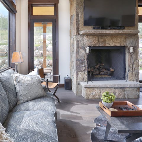 Cosy up by the fireplace in the elegant living room 