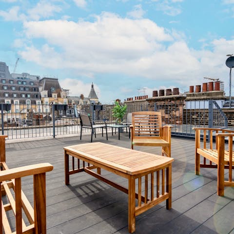Head up to the apartment's private rooftop terrace and inspect the London skyline