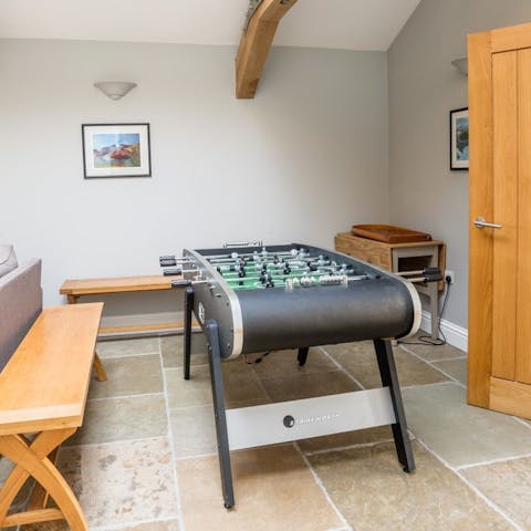 Challenge all comers to a game of table football in the living area