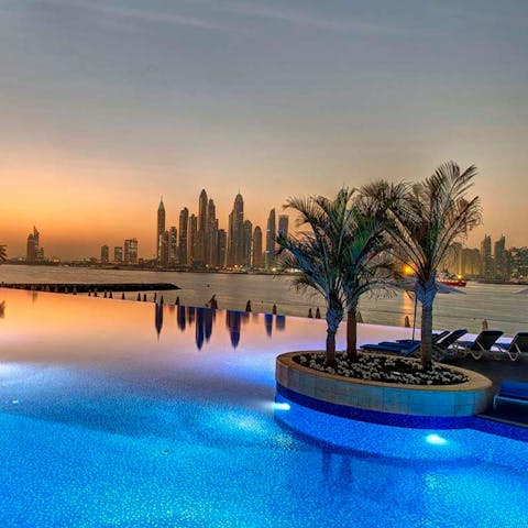 Unwind with a sunset swim in the shared infinity pool