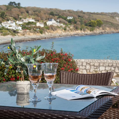 Watch the sun go down and the sea shimmer with a crisp glass of wine