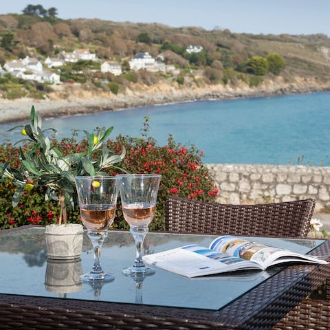 Watch the sun go down and the sea shimmer with a crisp glass of wine