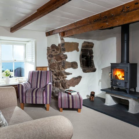 Read your book in the cosy armchair beside the warming fireplace