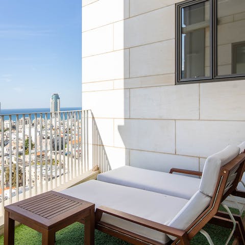 Watch the sun set over Tel Aviv from your private balcony