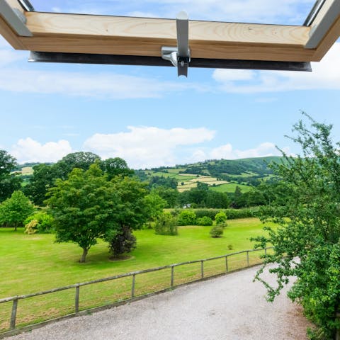 Admire the stunning vistas across two acres of garden from your bedroom window