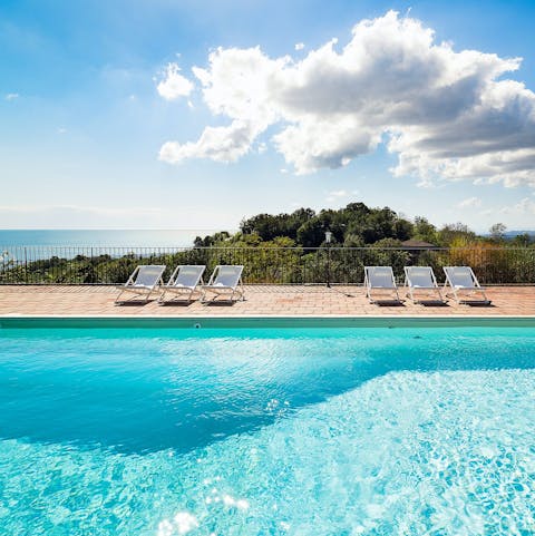 Relax by the pool as you look out to the Ionian sea