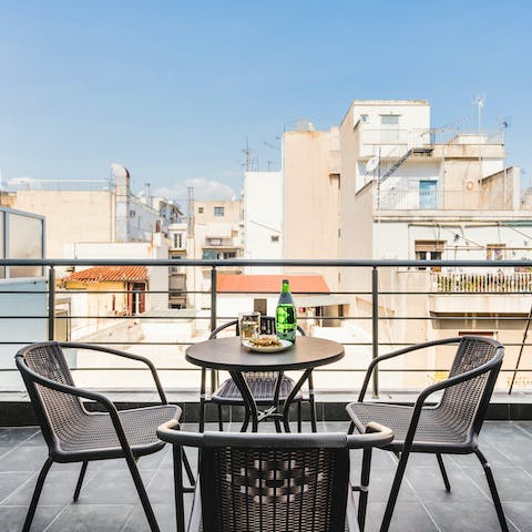 Enjoy a pint of Mythos on the private balcony
