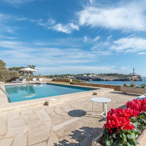 Enjoy a swim with Portocolom lighthouse as your backdrop