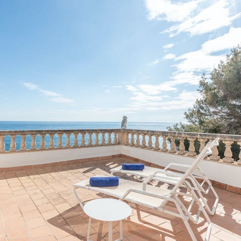 Stretch out on a sun lounger and soak up the sea views from the terrace
