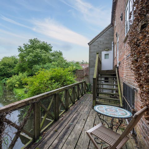 Stay in a gorgeous converted mill, with views across the stream