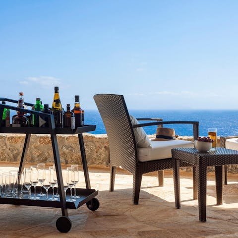 Mix your favourite cocktail to sip as you admire the sea view