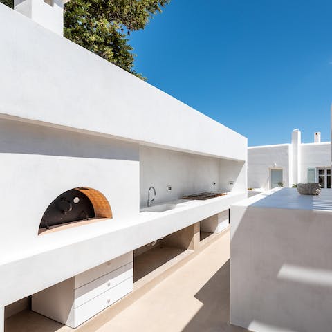 Cook up delicious Greek cuisine with the built-in barbecue and wood fire oven