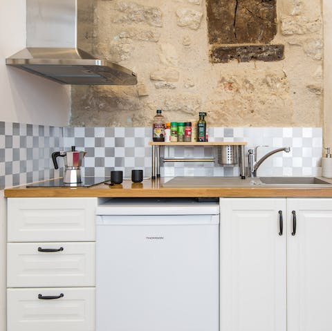 Plate up in a characterful kitchen with exposed brick walls and a chequered backsplash 