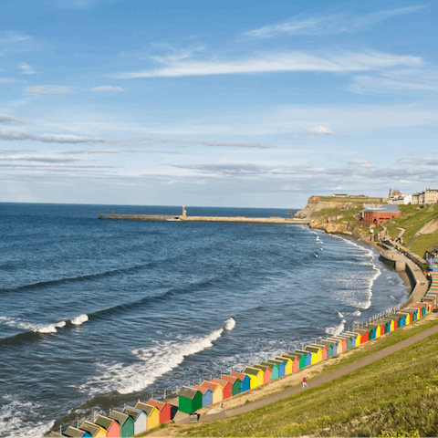 Stroll to West Cliff Beach to skim stones and check out the colourful beach huts