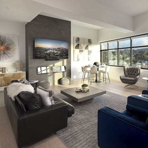 Unwind in the contemporary living area with wall-to-wall windows overlooking downtown 