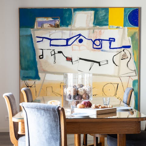 Dine in style by the large abstract paintings in the living space