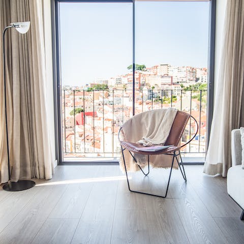 Admire the views of Alfama and the Castelo São Jorge from your living room's balcony