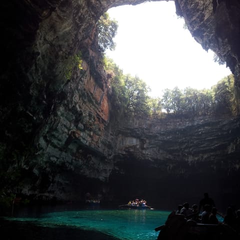 Stroll five minutes through the village to Melissani Cave